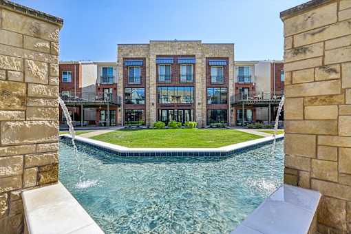 A swimming pool is surrounded by a stone wall.
