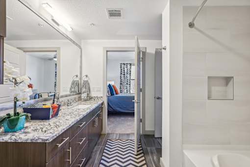 A bathroom with a white tub and a zig zag rug.