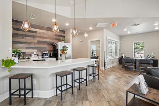 A kitchen with a bar area and a dining table.