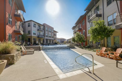 a swimming pool in the middle of two apartment buildings