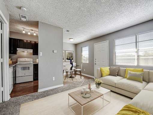 A modern living room with a white couch and a coffee table.