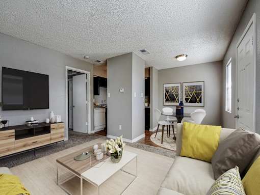 A living room with a white couch and a coffee table.