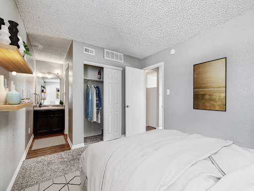 A bedroom with a large bed and a wardrobe.