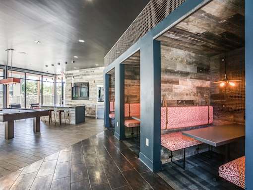 A modern restaurant with a rustic touch, featuring a wooden table and benches.