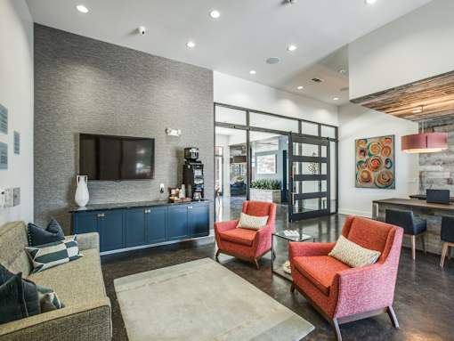 A living room with a grey wall and a flat screen TV.