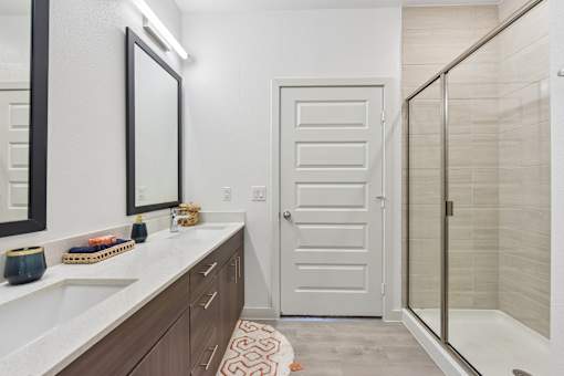 A bathroom with a white sink and a white door.