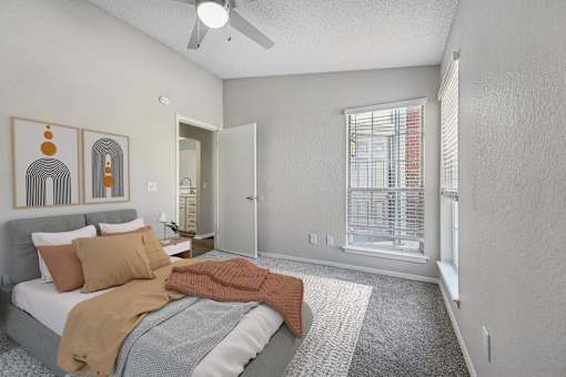 a bedroom with a bed and a ceiling fan