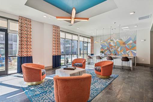 A room with orange chairs and a ceiling fan.