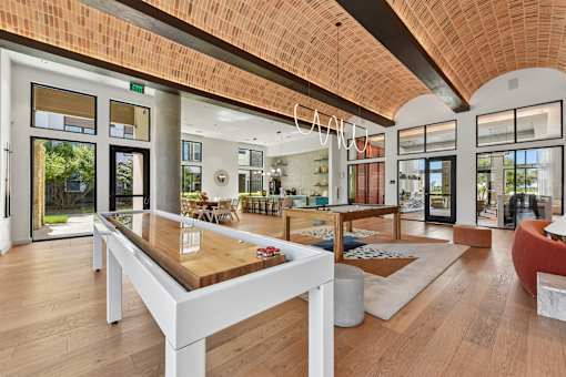 A modern dining room with a wooden table and chairs.