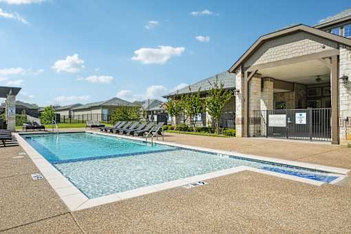 A swimming pool with a building in the background.
