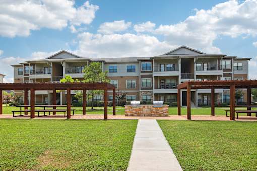 A large apartment complex with a walkway leading to the front door.