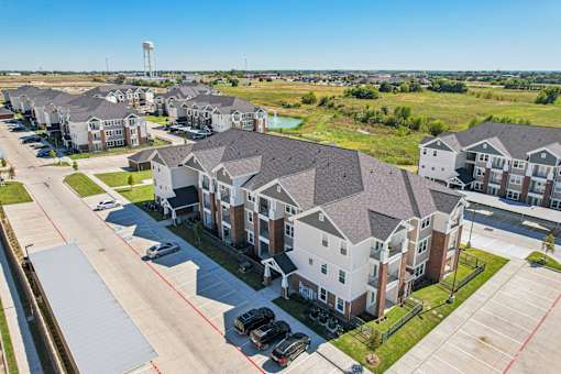 A row of houses with a water tower in the distance.