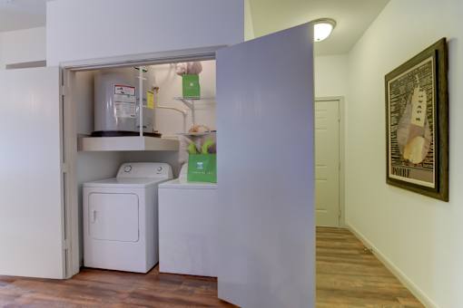 A small kitchen with a refrigerator and a washing machine.