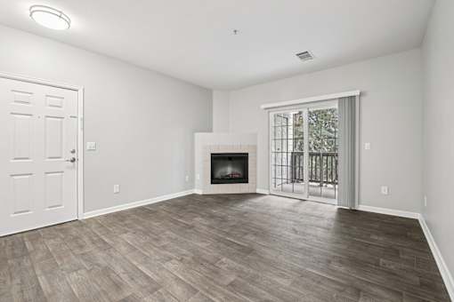 A room with a fireplace and a sliding glass door.
