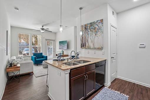 A kitchen with a white counter top and brown cabinets.