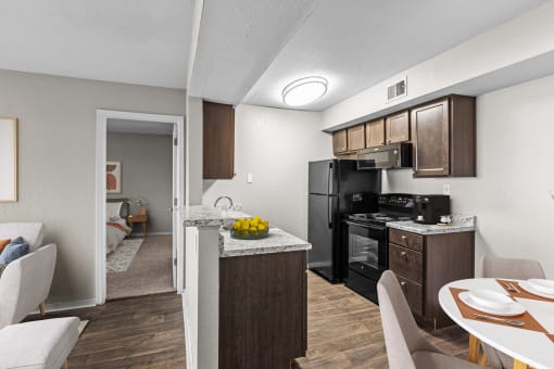 our apartments have a kitchen and dining room with a table and chairs