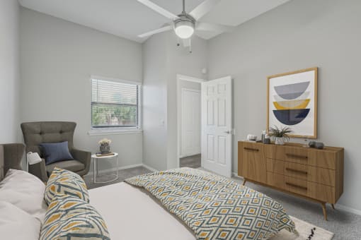 a bedroom with a large bed and a ceiling fan