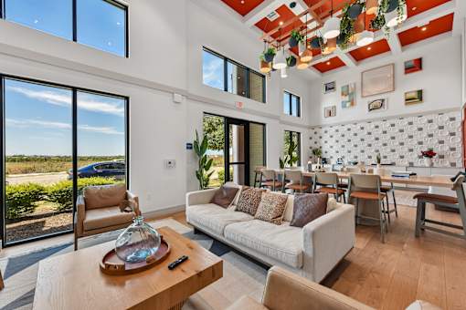 A modern living room with a white couch and a wooden coffee table.