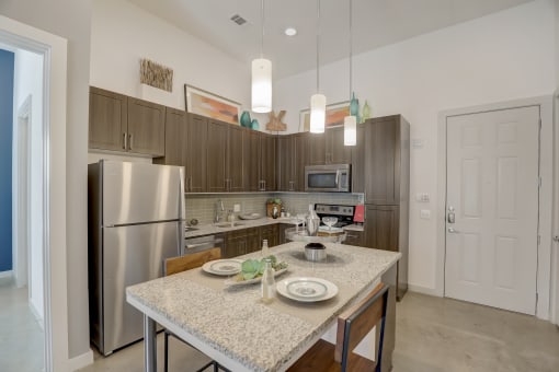 a kitchen with stainless steel appliances and a granite counter top