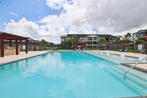 A large swimming pool in front of a building.