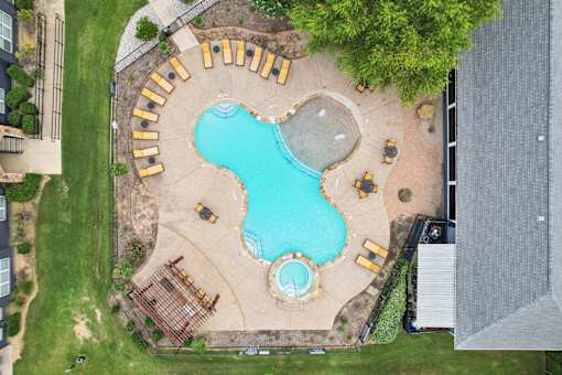 A large outdoor pool with a sign that says "MUJIN".