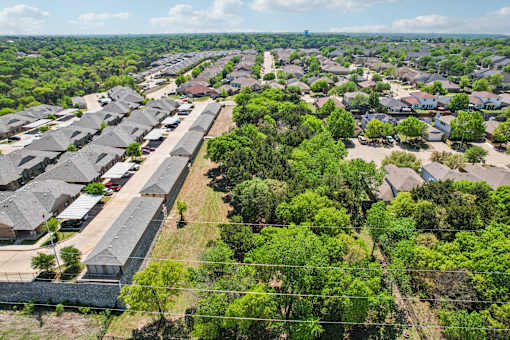 A bird's eye view of a residential area with houses and trees.