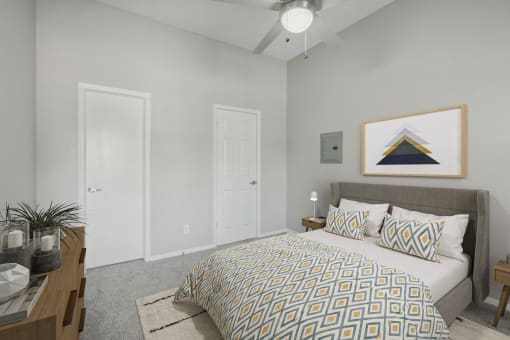 a bedroom with a large bed and a ceiling fan