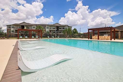 A large swimming pool in front of a building.