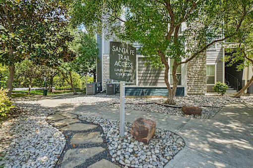 A sign for Santa Fe Trail Access in front of a building.