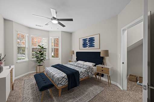 a bedroom with a large bed and a ceiling fan