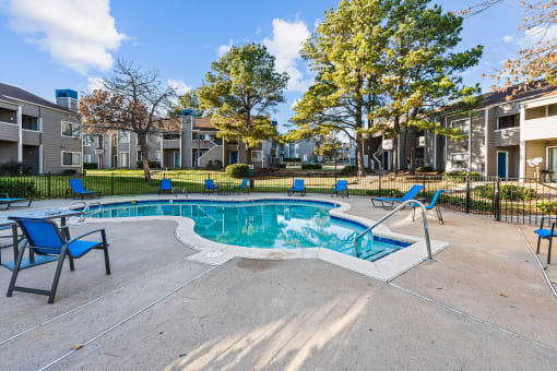 the preserve at ballantyne commons pool with blue chairs and apartment buildings