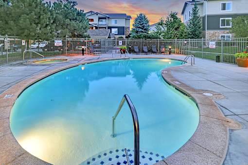 A small pool with a ladder in the middle of it.
