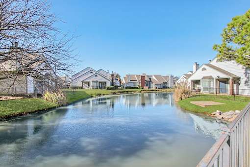 A serene residential area with a canal running through it.