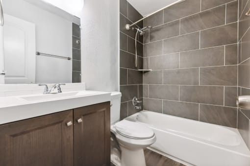 a bathroom with a sink toilet and bath tub