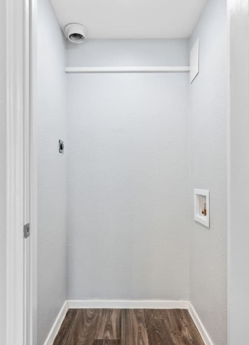 room with white walls and wood flooring and a white door