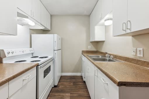 a kitchen with white appliances and white cabinets