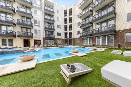 an apartment building with a pool in the middle of it