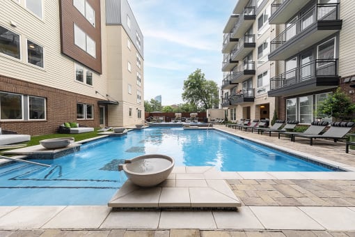 a swimming pool in front of an apartment building