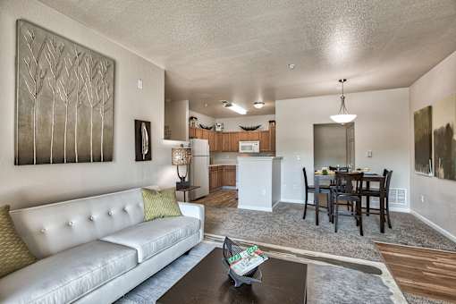 A modern living room with a white couch and a coffee table.