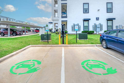 A parking lot with a green symbol painted on the pavement.