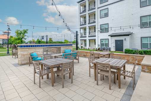 A patio with a table and chairs is set up outside a building.