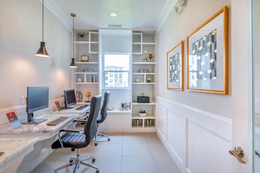 A home office with a desk, chair, and computer setup.