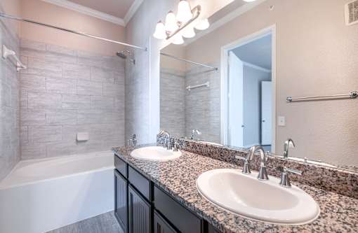 A bathroom with a white sink and a white bathtub.