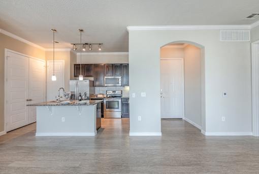 A kitchen with a sink, stove, and refrigerator.