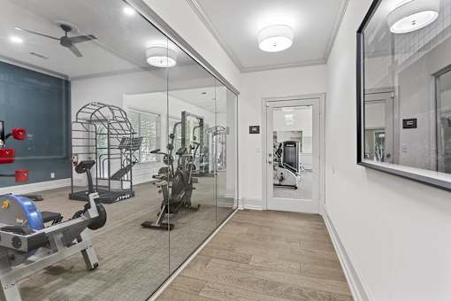 the gym in the owners home is equipped with a treadmill and weights