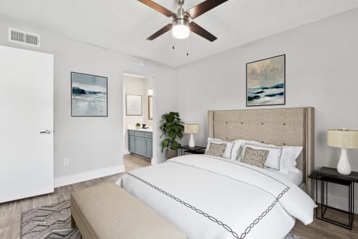 a bedroom with a bed and a ceiling fan