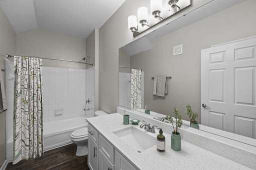 a bathroom with a sink and a shower and a toilet