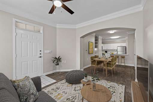 A living room with a grey couch and a wooden coffee table.