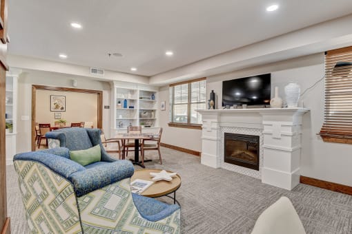 a living room with a fireplace and a tv