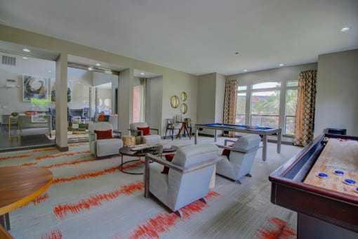 a large living room with a pool table and a foosball table